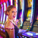 Young woman playing slot machines at the Casino