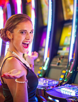 Young woman playing slot machines at the Casino