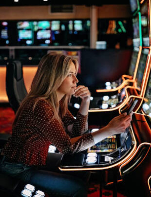 Women gambling on slot machinery