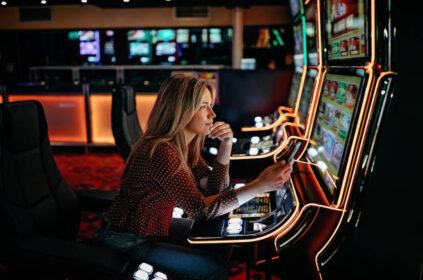 Women gambling on slot machinery